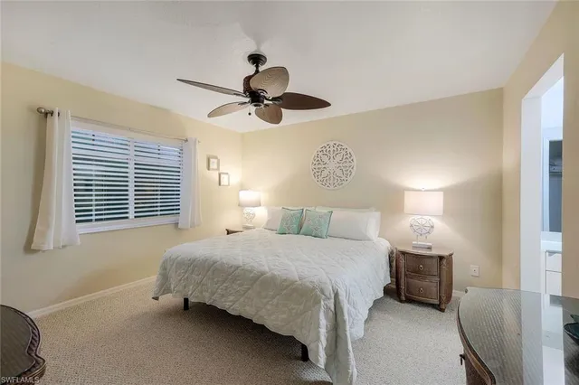 a bedroom with a bed a lamp and a window