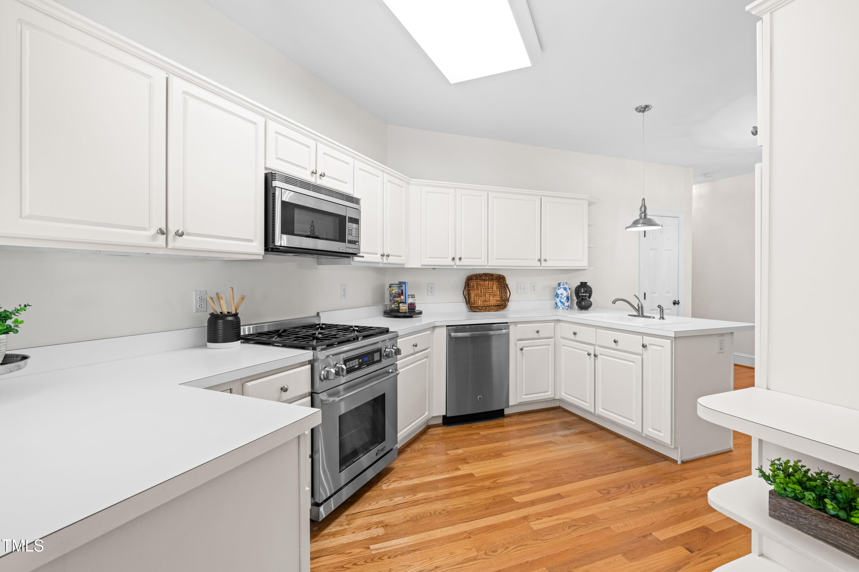 2909 Hawtree Drive Raleigh, NC 27613 - Photo 12 of 38 a kitchen with a sink stove and microwave