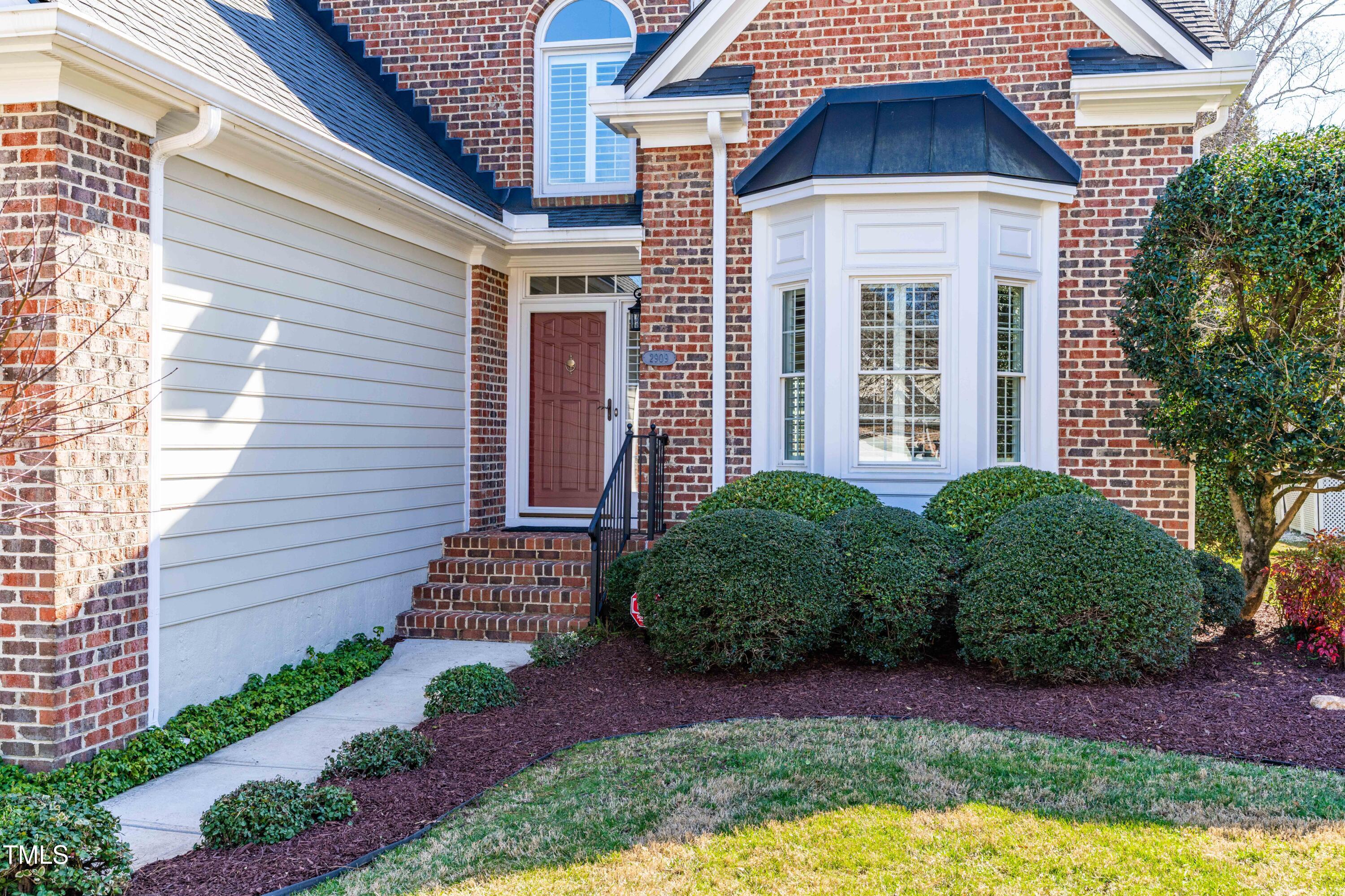 2909 Hawtree Drive Raleigh, NC 27613 - Photo 2 of 38 a view of a brick house with plants and many windows