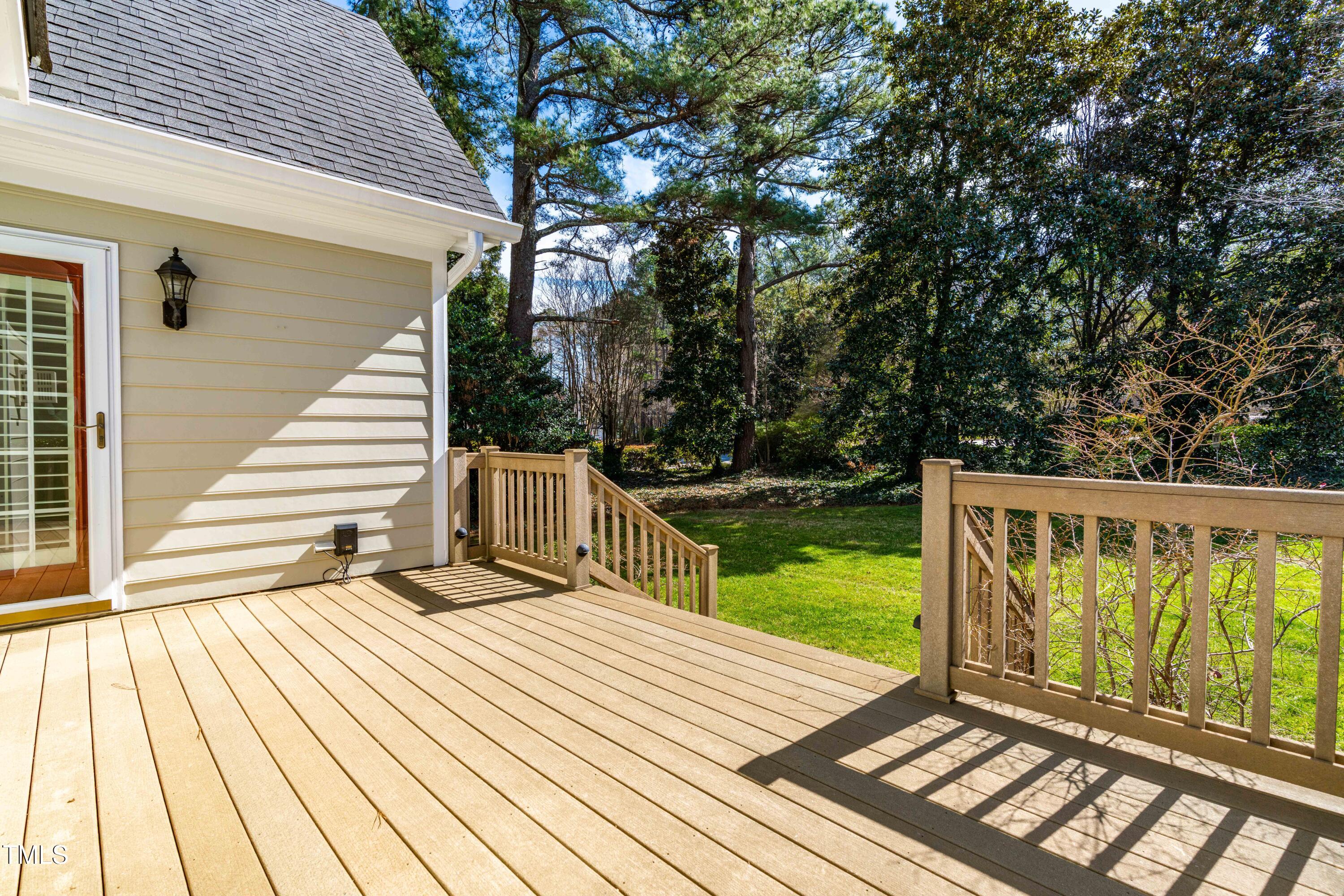 2909 Hawtree Drive Raleigh, NC 27613 - Photo 34 of 38 a view of a balcony with wooden floor and fence next to a yard