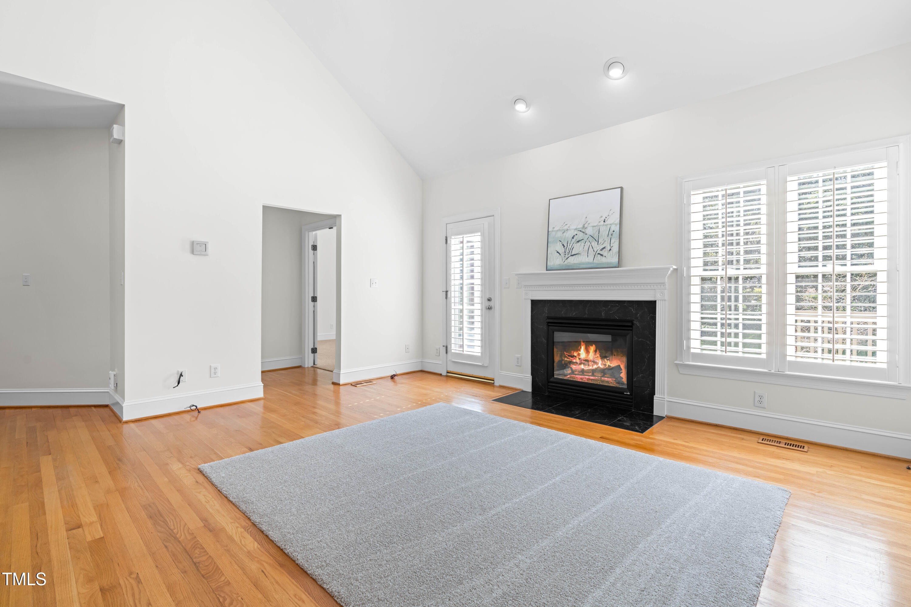 2909 Hawtree Drive Raleigh, NC 27613 - Photo 8 of 38 an empty room with a fireplace and window