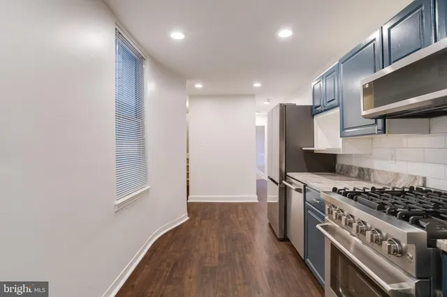 a kitchen with stainless steel appliances granite countertop a stove and a refrigerator