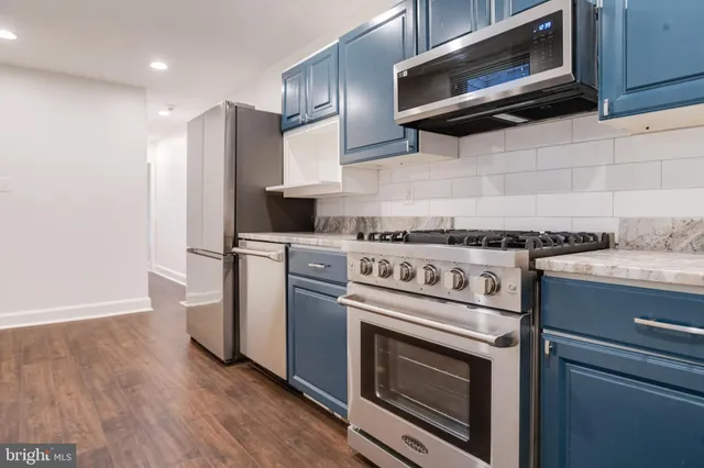a kitchen with stainless steel appliances and cabinets