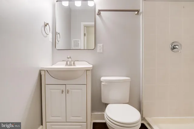 a bathroom with a sink toilet and a mirror