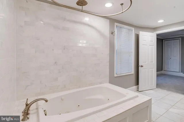 a bathroom with a bathtub and a shower