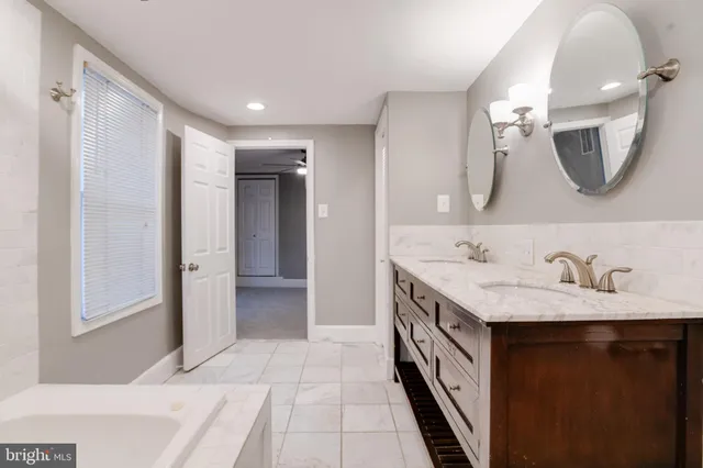 a bathroom with a double vanity sink and a mirror