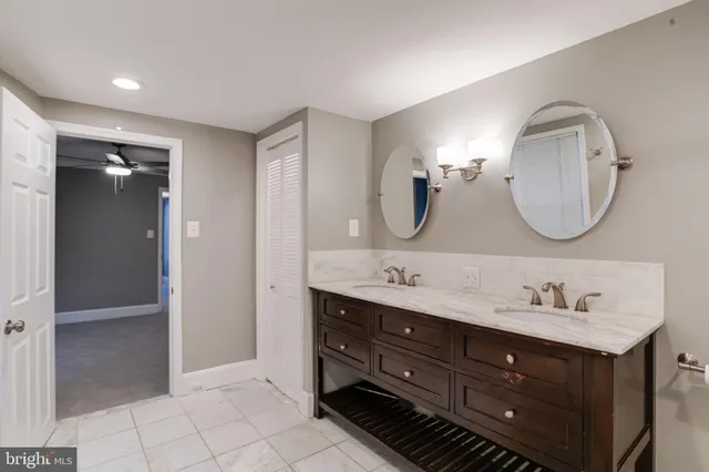 a en suite bathroom with a double vanity sink double and mirror