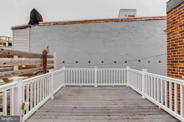 a view of a balcony with wooden floor