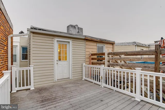 a view of a balcony with chair and wooden floor