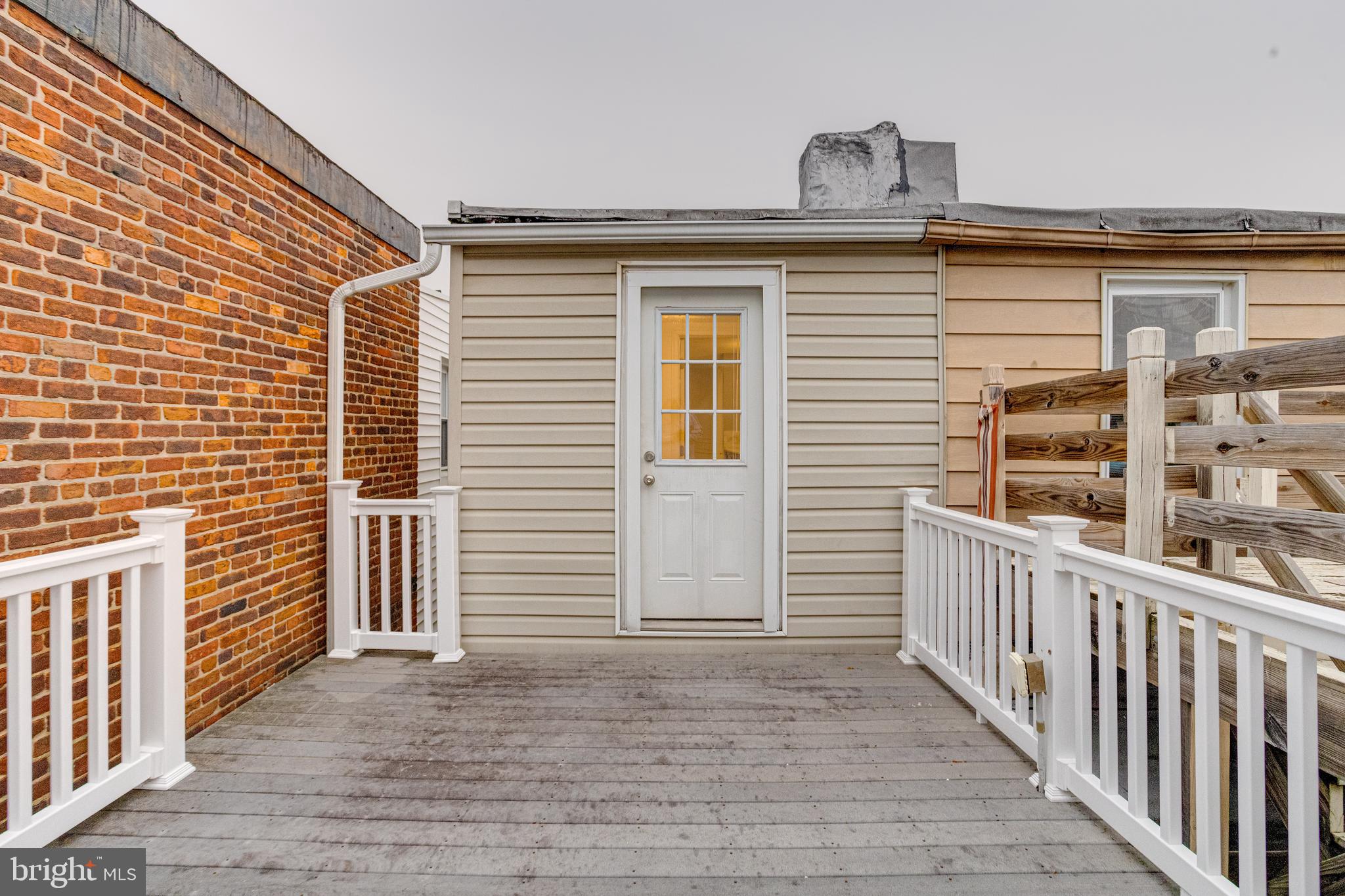 1313 Patapsco Street Baltimore, MD 21230 - Photo 34 of 52 a view of a balcony with chair and wooden floor