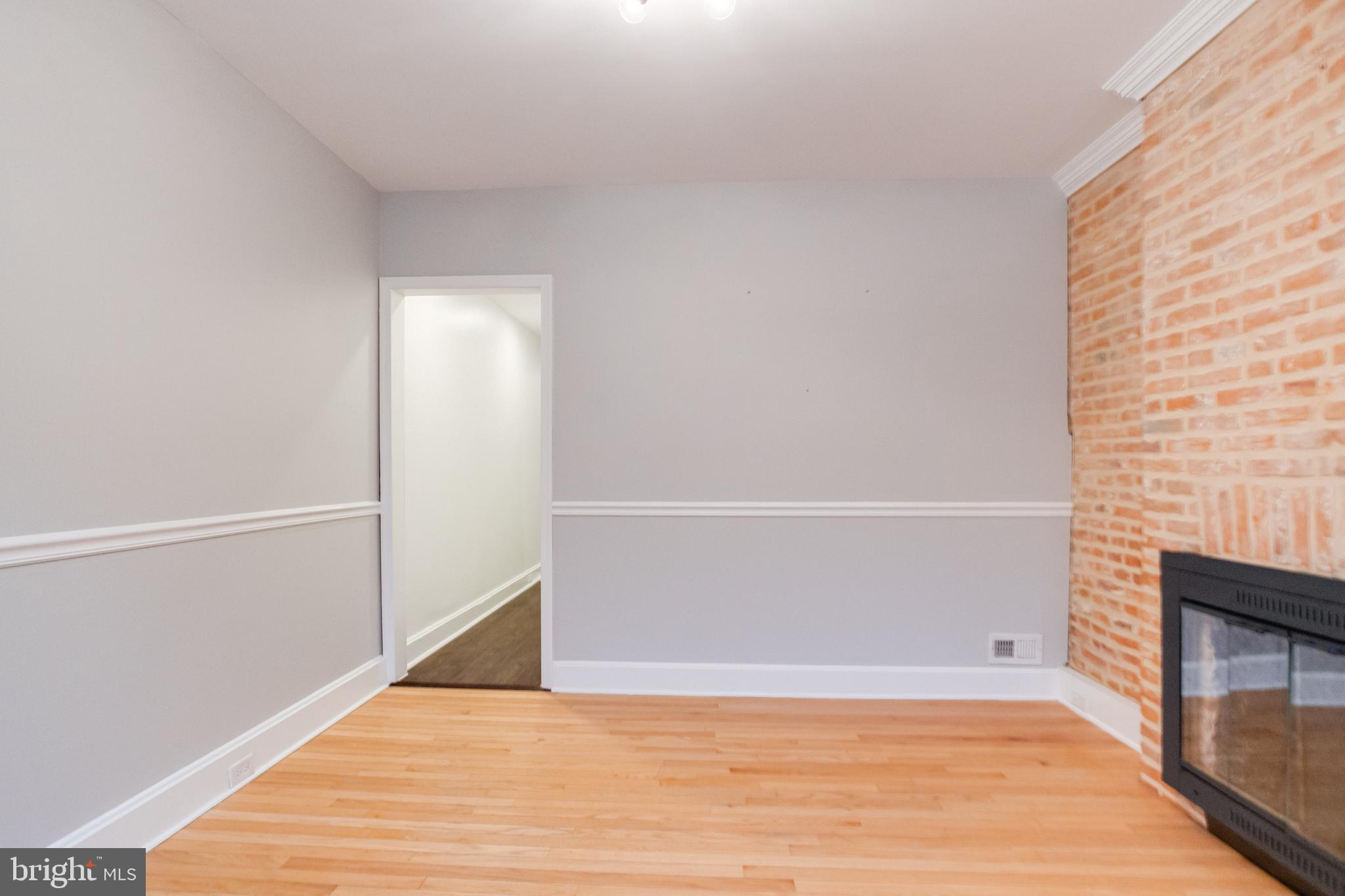 1313 Patapsco Street Baltimore, MD 21230 - Photo 4 of 52 a view of an empty room with wooden floor and a window