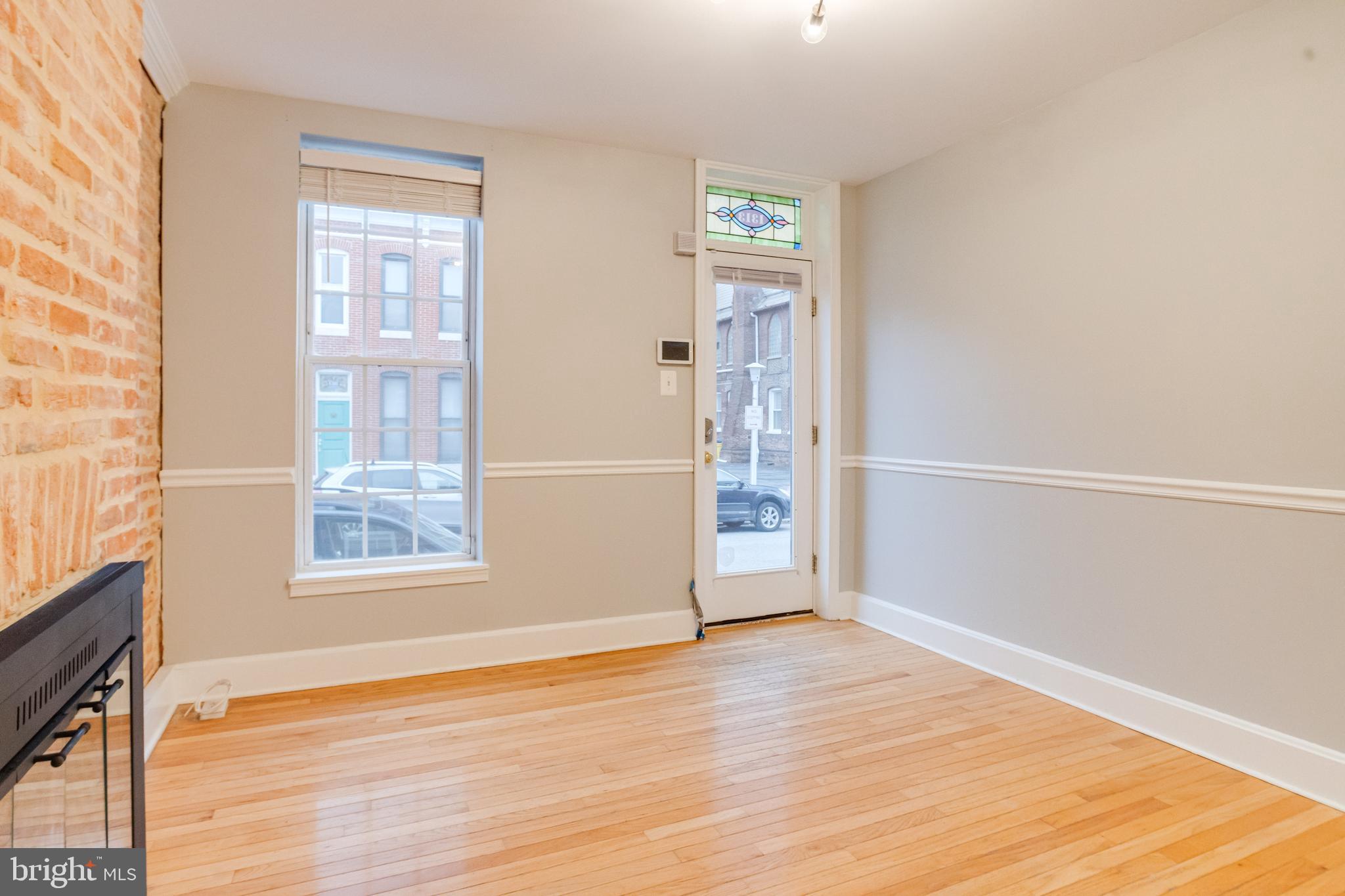 1313 Patapsco Street Baltimore, MD 21230 - Photo 6 of 52 an empty room with wooden floor and windows