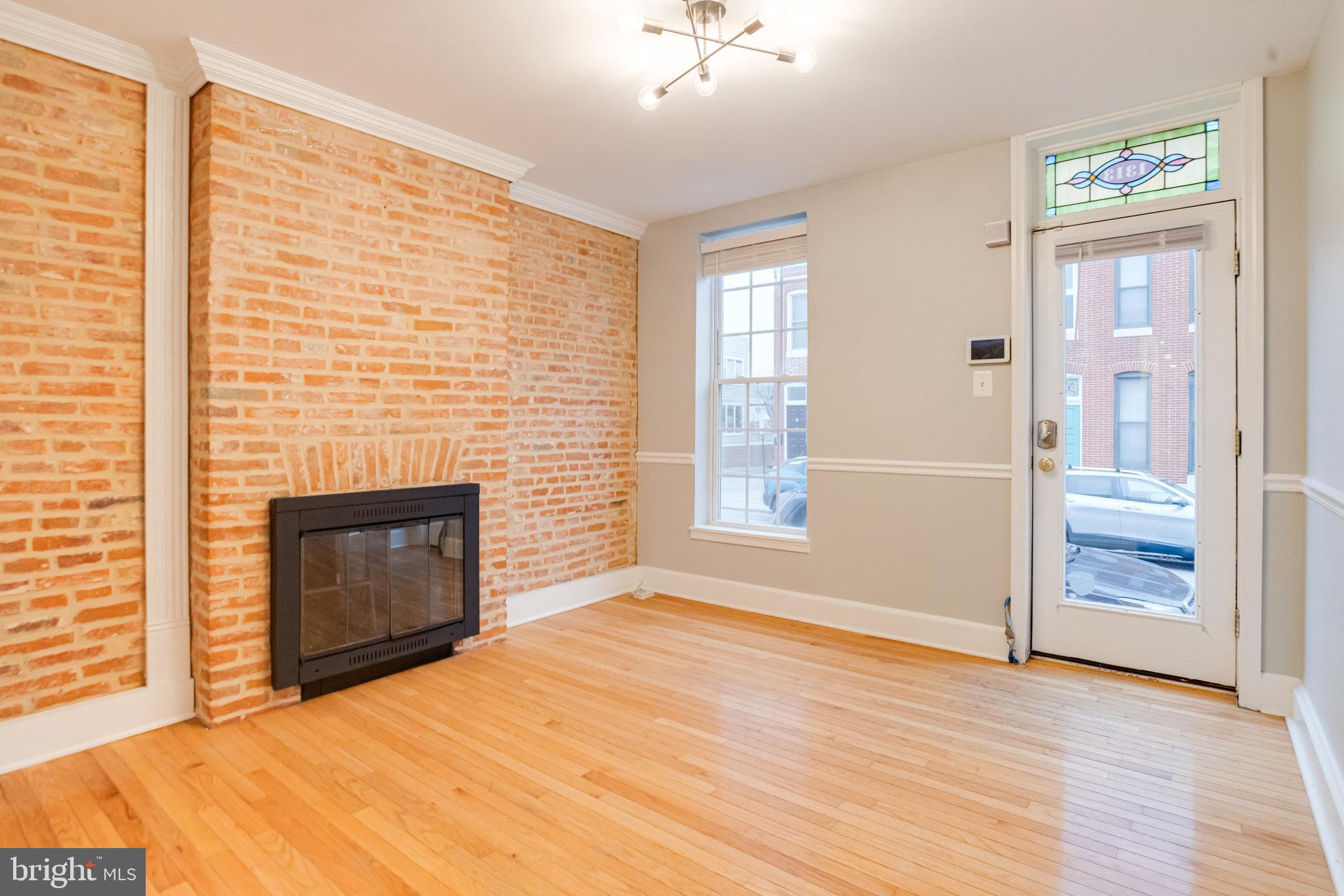 1313 Patapsco Street Baltimore, MD 21230 - Photo 7 of 52 an empty room with windows and fireplace