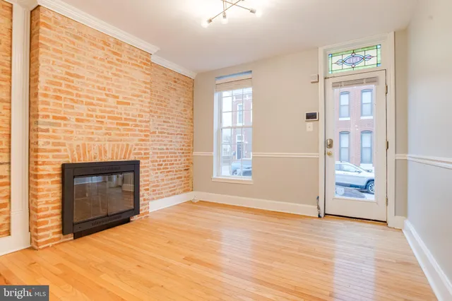 a room with a fireplace and wooden floor