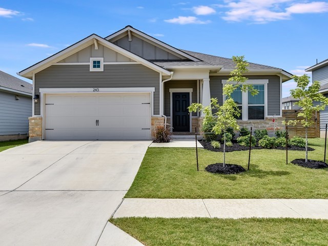 a front view of house with a garden