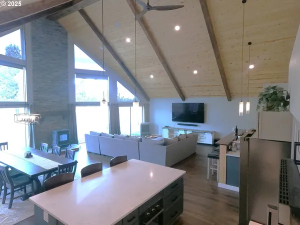 a living room with lots of furniture and view of kitchen
