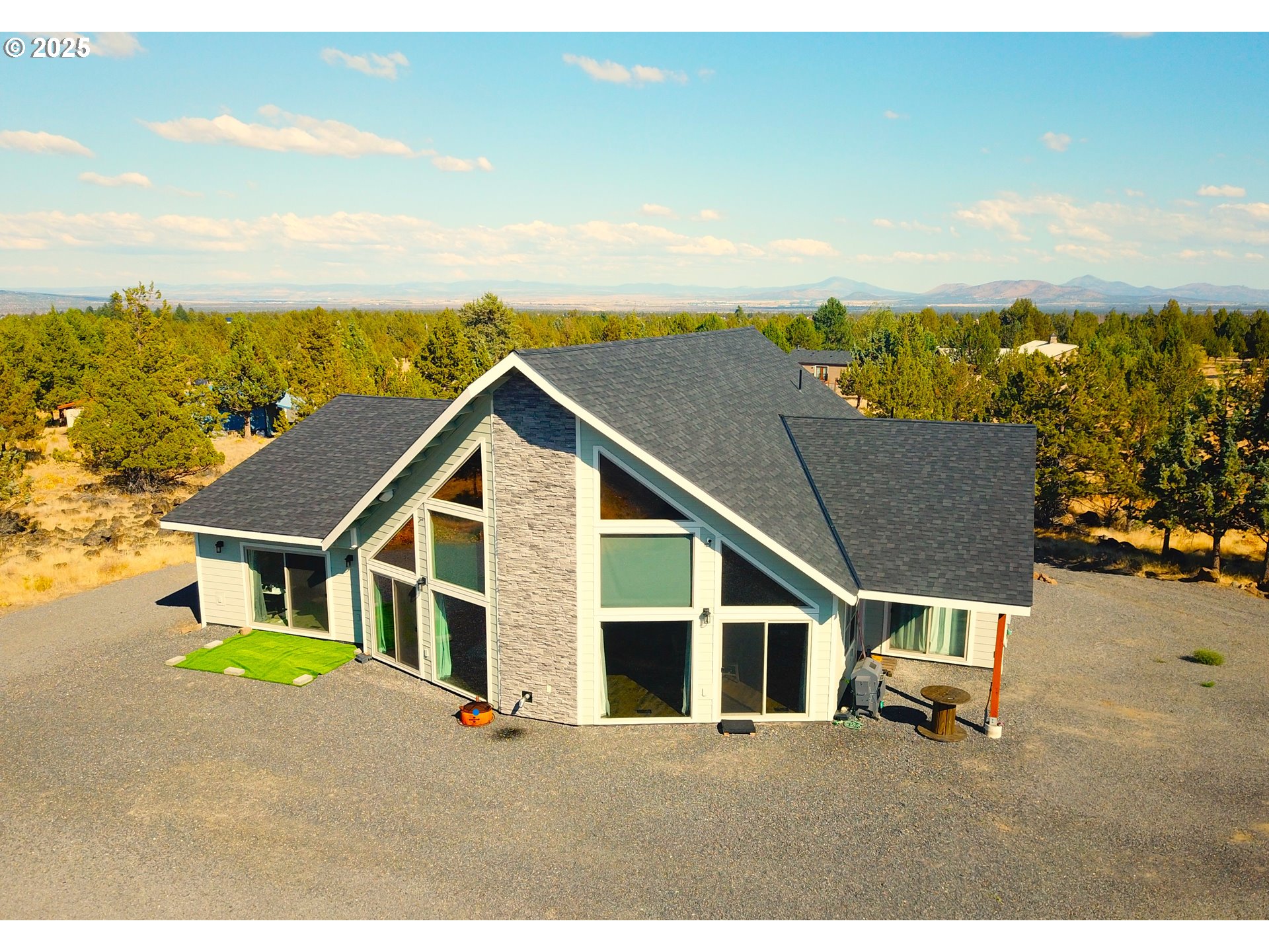 13422 Southwest Airfield Lane Culver, OR 97734 - Photo 2 of 42 a backyard of a house with wooden floor and city view