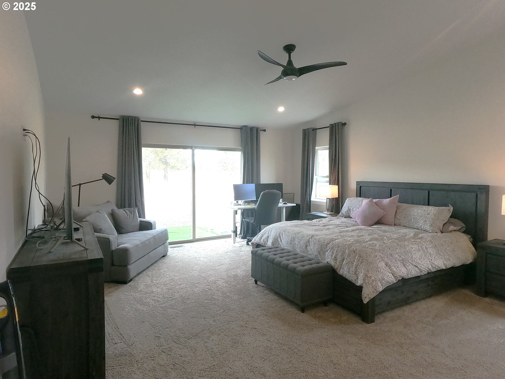 13422 Southwest Airfield Lane Culver, OR 97734 - Photo 21 of 42 a spacious bedroom with a bed a couch and a large window