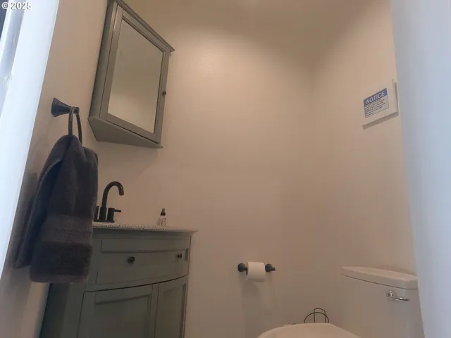 a bathroom with a double vanity sink toilet and shower