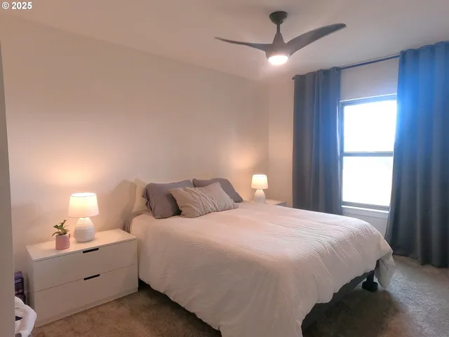 a bedroom with a bed and a window