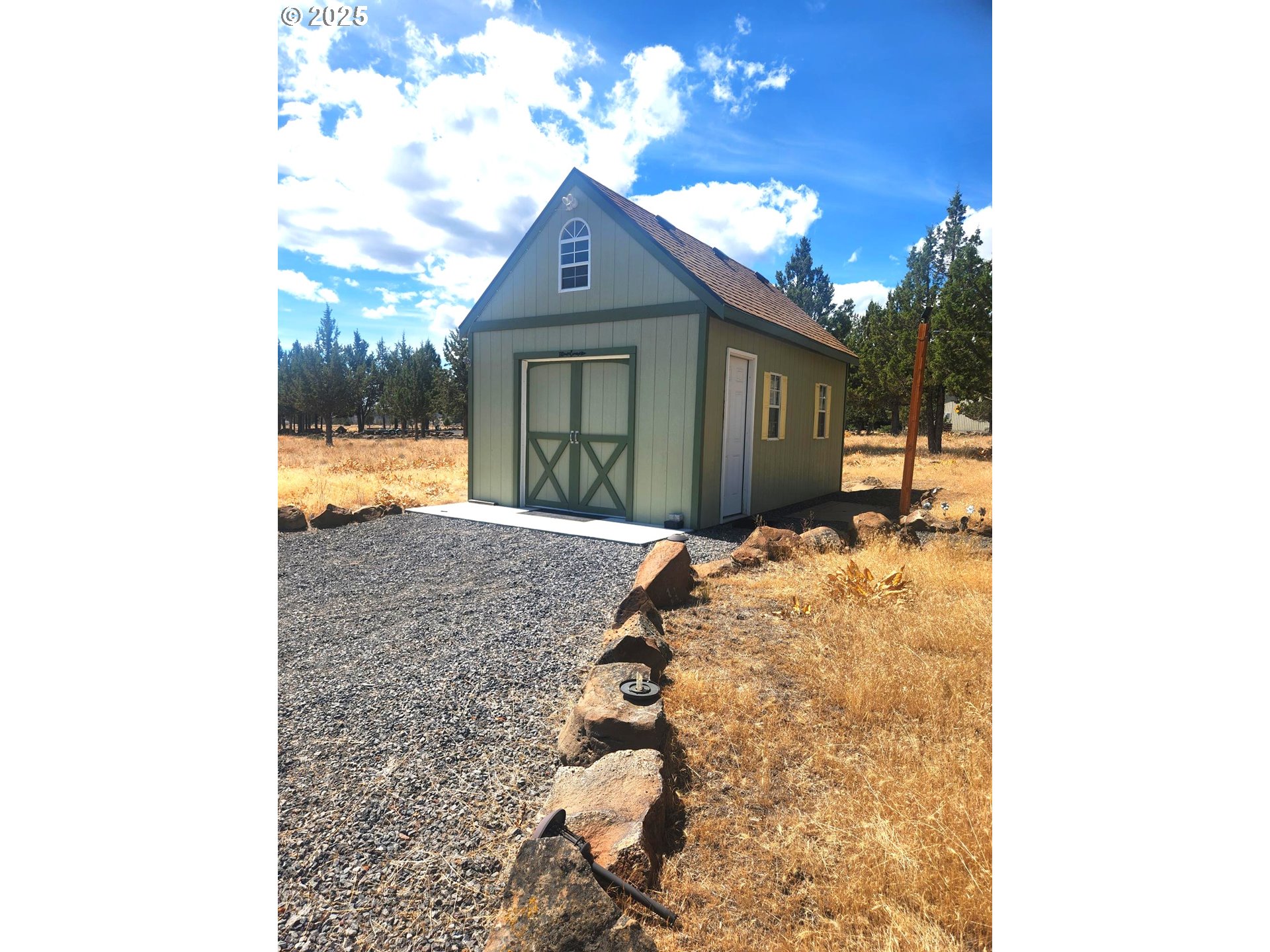 13422 Southwest Airfield Lane Culver, OR 97734 - Photo 32 of 42 a view of a house with a yard and garage