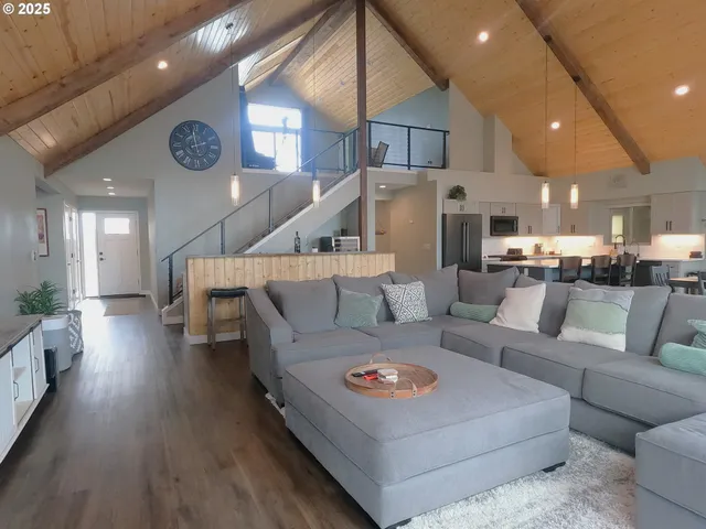 a living room with furniture and kitchen view