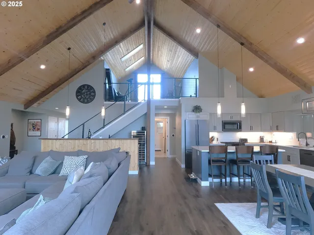 a living room with lots of furniture and kitchen view