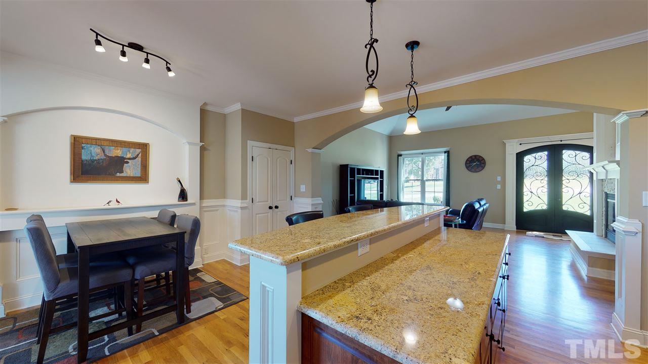 3537 Saddle Ridge Road Stem, NC 27581 - Photo 12 of 29 a view of a dining room with furniture and a chandelier