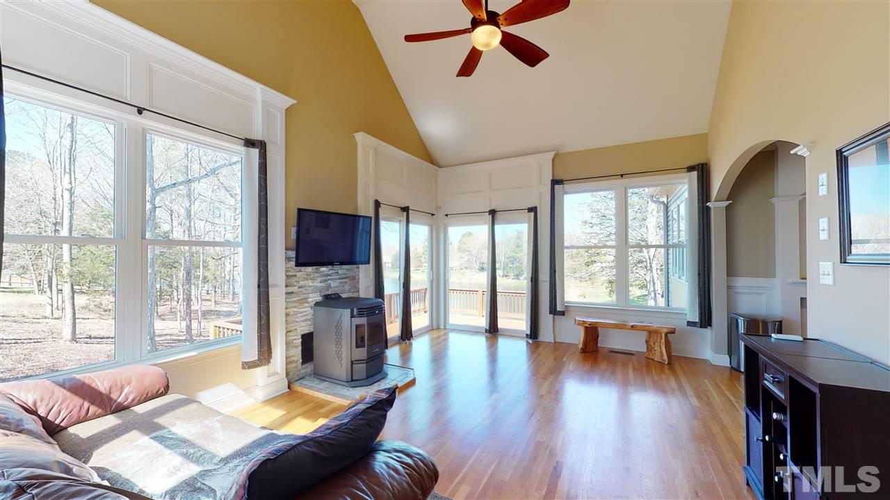 3537 Saddle Ridge Road Stem, NC 27581 - Photo 16 of 29 a living room with fireplace furniture and a wooden floor
