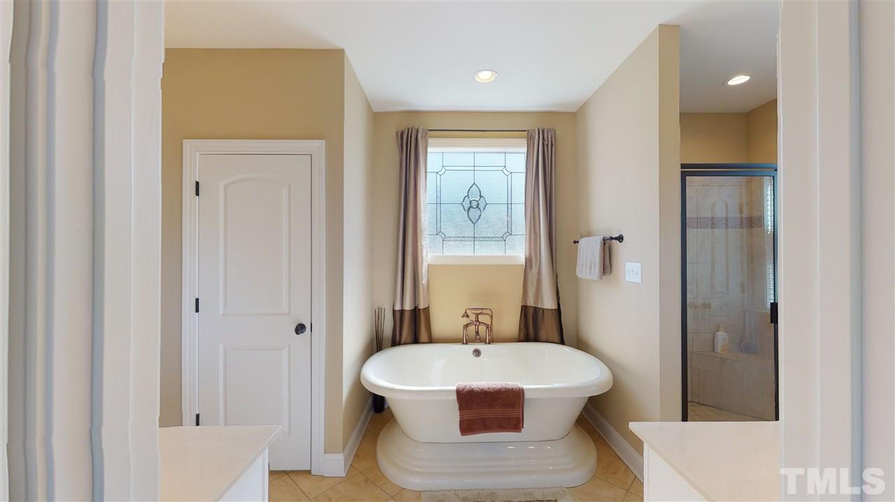 3537 Saddle Ridge Road Stem, NC 27581 - Photo 19 of 29 a bathroom with a bathtub and a sink
