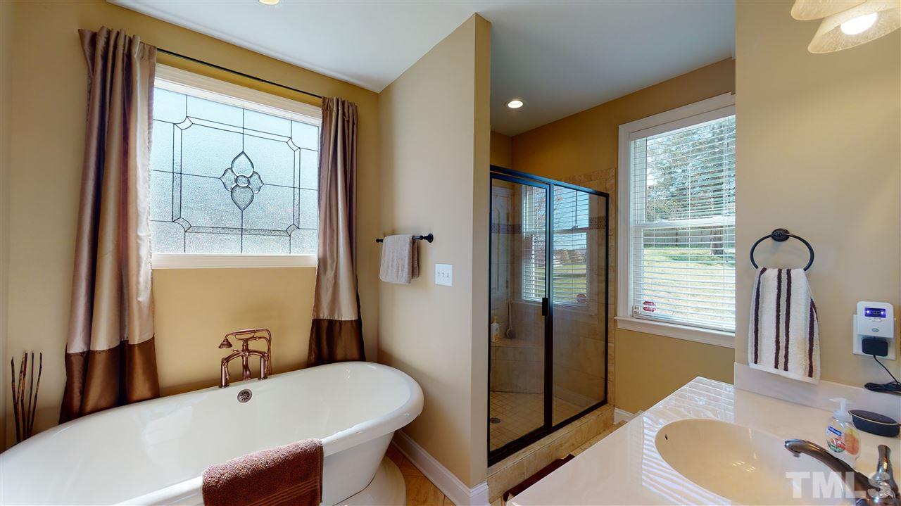 3537 Saddle Ridge Road Stem, NC 27581 - Photo 20 of 29 a bathroom with a tub and a sink