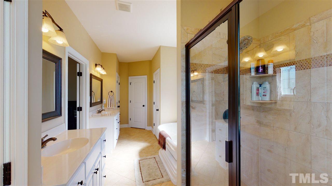 3537 Saddle Ridge Road Stem, NC 27581 - Photo 21 of 29 a bathroom with a tub shower and sink