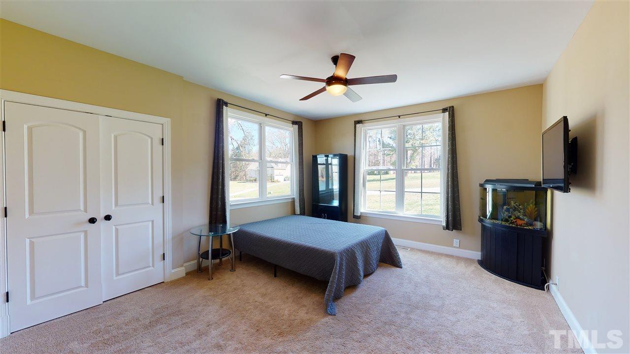 3537 Saddle Ridge Road Stem, NC 27581 - Photo 6 of 29 a living room with a bed furniture and a flat tv screen
