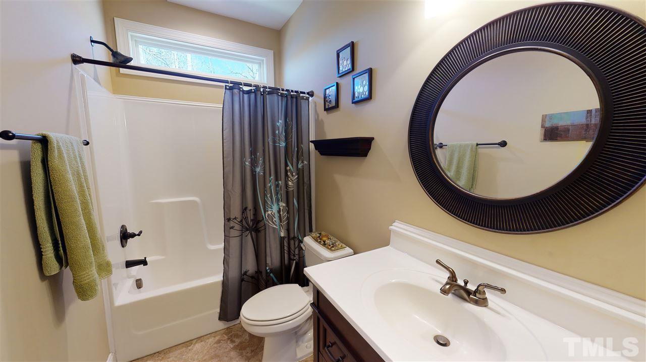 3537 Saddle Ridge Road Stem, NC 27581 - Photo 8 of 29 a bathroom with a sink a toilet and a mirror
