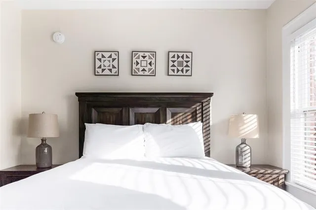 a bedroom with a bed and a night stand