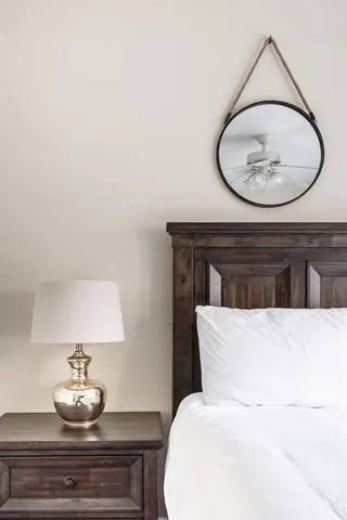 a bedroom with a bed and a potted plant