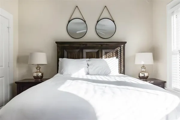 a bedroom with bed and chair