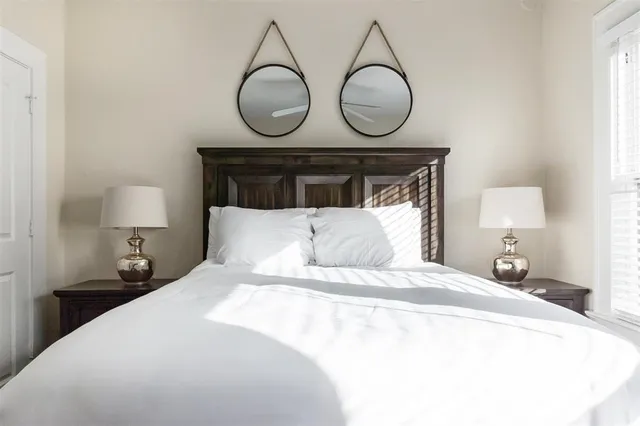 a bedroom with bed and chair