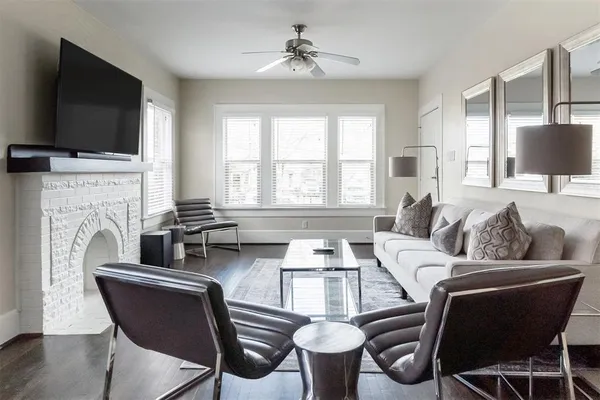a living room with furniture fireplace and flat screen tv