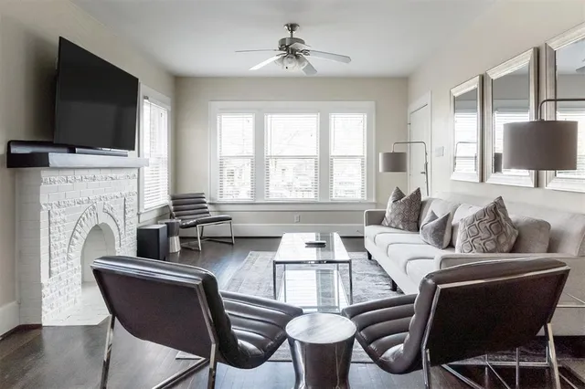 a living room with furniture fireplace and flat screen tv