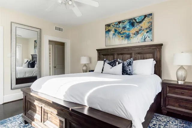 a bedroom with a bed and a painting on the wall