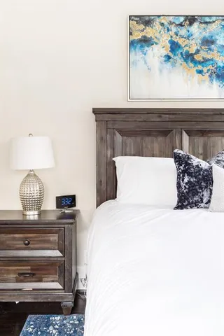 a bedroom with a bed and wall paintings