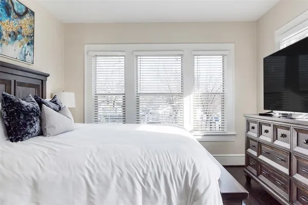 a bedroom with a bed and a flat screen tv