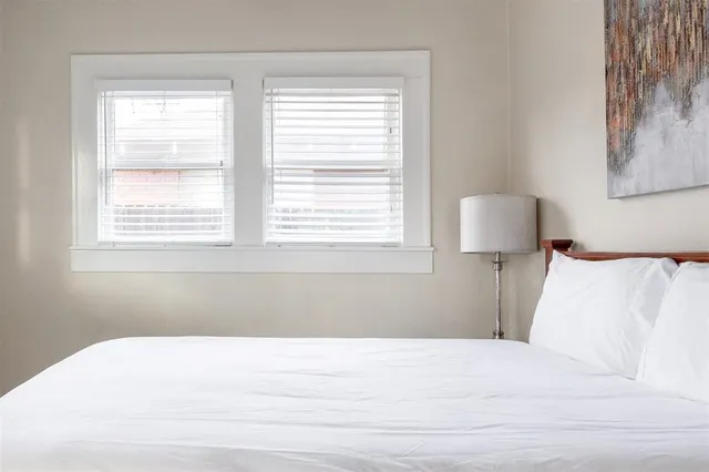 a bed room with a bed and a night stand