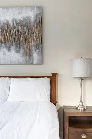 a bedroom with a bed and a lamp