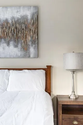 a bedroom with a bed and a lamp