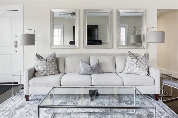 a living room with a couch and a mirror