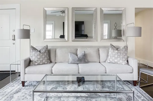 a living room with a couch and a mirror