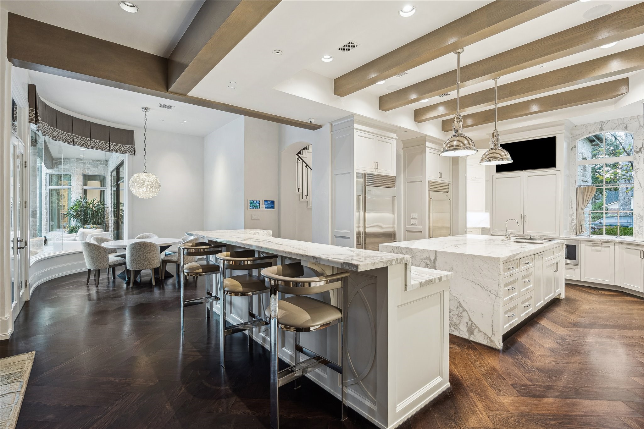 220 Merrie Way Lane Houston, TX 77024 - Photo 13 of 50 Perfectly placed between the breakfast area and living spaces, the kitchen is designed for both everyday ease and hosting.