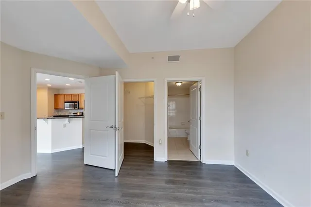 a view of empty room with wooden floor